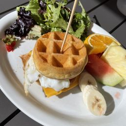 Brunchwich on mini waffle with egg and cheese side of salad and fruit Brunchwich on mini waffle with egg and cheese side of salad and fruit