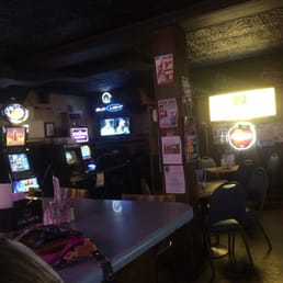 a bar with a lot of tvs