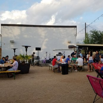 Axelrad - The wall where the movie magic happens and the DJ spins his music - Beer Gardens Near Me - Houston, Texas Axelrad - The wall where the movie magic happens and the DJ spins his music - Beer Gardens Near Me - Houston, Texas