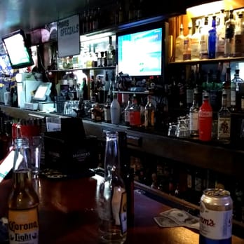 The Lariat Tavern - a man using his cell phone - Sports Bars Near Me - Belmont, California