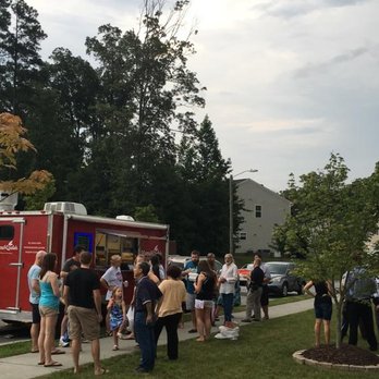 Mama Voula's - a group of people standing outside of a food truck - Mediterranean Near Me