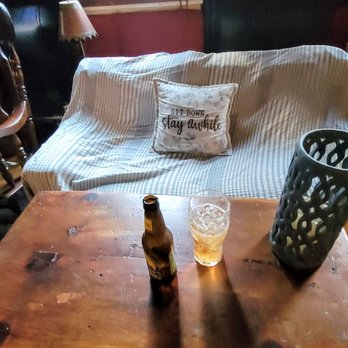 The Quays Pub - a table with a bottle of beer on it - Pubs Near Me - Astoria, New York The Quays Pub - a table with a bottle of beer on it - Pubs Near Me - Astoria, New York