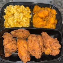 Fried chicken, mac and cheese and yams individual plate