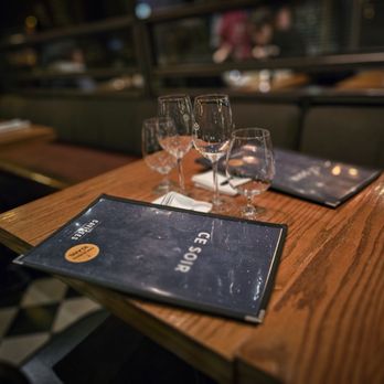 Les Cavistes - a menu and wine glasses on a table - French Near Me - Montreal, Quebec Les Cavistes - a menu and wine glasses on a table - French Near Me - Montreal, Quebec