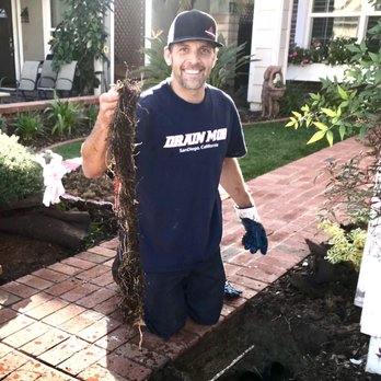 San Diego Drain Krew - Nick Krewson with a large plug of roots which clogged our underground drainage pipe. - Plumbing Near Me