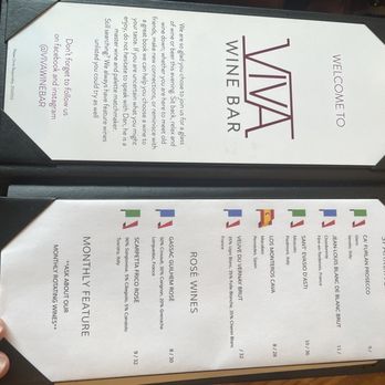 Viva Wine Bar - a menu and a person's hand - Wine Bars Near Me - Anderson, South Carolina Viva Wine Bar - a menu and a person's hand - Wine Bars Near Me - Anderson, South Carolina