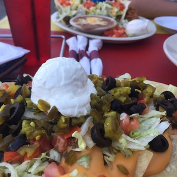 Anita's Riverfront Grille - Nacho supreme and soft tacos in the background. - Pizza Near Me - Marine City, Michigan Anita's Riverfront Grille - Nacho supreme and soft tacos in the background. - Pizza Near Me - Marine City, Michigan
