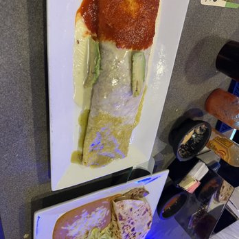 Casamigos - Burritos Mexicanos & carnitas quesadilla. - A burrito covered with red sauce and a quesadilla served with a side salad are displayed on white plates at a restaurant. - Mexican Near Me - Concord, New Hampshire