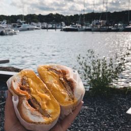 sausage, egg, and cheese on a crossiant, eggs over medium with salt pepper and hot sauce sausage, egg, and cheese on a crossiant, eggs over medium with salt pepper and hot sauce