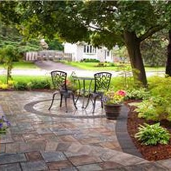 Wentworth Landscapes - a patio with a table and chairs - Landscaping Near Me - Picton, Ontario Wentworth Landscapes - a patio with a table and chairs - Landscaping Near Me - Picton, Ontario
