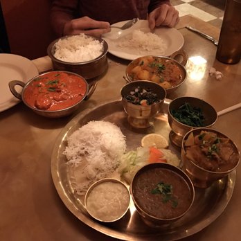 Yak The Kathmandu Kitchen - Salmon masala, aalu tarkari and veg thali in the foreground. - Indian Near Me - Mobile, Alabama Yak The Kathmandu Kitchen - Salmon masala, aalu tarkari and veg thali in the foreground. - Indian Near Me - Mobile, Alabama