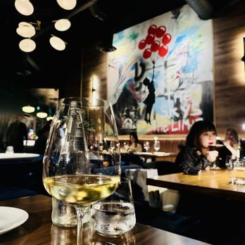 Il Girasole - The interior is stunning (elegant Italian artistic touches) warm lighting, cozy ambiance, beautiful painting adds character to the space. - Italian Near Me - Costa Mesa, California