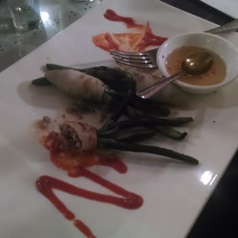 Sunset Phở Caffe - Half eaten stuffed calamari with Saracha sauce. - Lounges Near Me - Chicago, Illinois Sunset Phở Caffe - Half eaten stuffed calamari with Saracha sauce. - Lounges Near Me - Chicago, Illinois