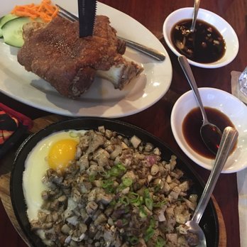 KAPATAD Kitchen and Cafe - Sizzling Pork Sisig and crispy pork shank with 2 seasoned soy sauce (vinegary & sweet) - Filipino Near Me - Austin, Texas KAPATAD Kitchen and Cafe - Sizzling Pork Sisig and crispy pork shank with 2 seasoned soy sauce (vinegary & sweet) - Filipino Near Me - Austin, Texas