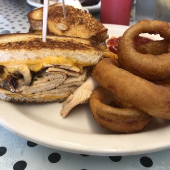The Worker Bee Cafe - The House-Brined Turkey Melt with beer battered onion rings. - Breakfast & Brunch Near Me - Carpinteria, California The Worker Bee Cafe - The House-Brined Turkey Melt with beer battered onion rings. - Breakfast & Brunch Near Me - Carpinteria, California
