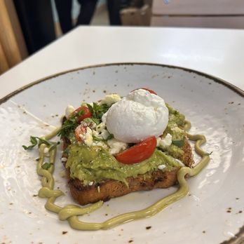 Bluestone Lane - Avocado Smash with a poached egg on gluten-free bread - Cafes Near Me - Newark, New Jersey Bluestone Lane - Avocado Smash with a poached egg on gluten-free bread - Cafes Near Me - Newark, New Jersey
