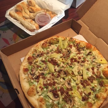 Riverboat Pizza - Pesto Manifesto and breadsticks. Pizza was outstanding but breadsticks were bland, flavorless and disappointing. - Pizza Near Me - Savannah, Georgia