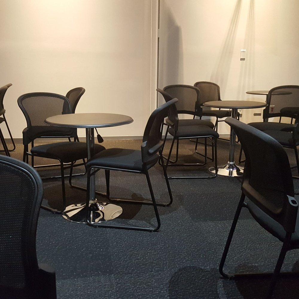 Des Moines Community Playhouse - Table seating area for the pre-performance entertainment. - Performing Arts Near Me - Des Moines, Iowa