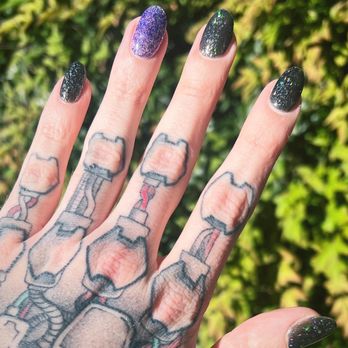 Soho Nail Lounge - Full set manicure with gel sparkles of black and purple on a hand with a mechanical robotic tattoo. - Nail Salons Near Me - Durham, North Carolina