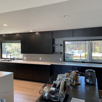 Gonzales Tile - a kitchen with black cabinets and white countertops - Flooring Near Me - Morgan Hill, California Gonzales Tile - a kitchen with black cabinets and white countertops - Flooring Near Me - Morgan Hill, California