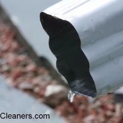 Rain Gutter Cleaning - Water dripping from the rain gutter after a spring rain