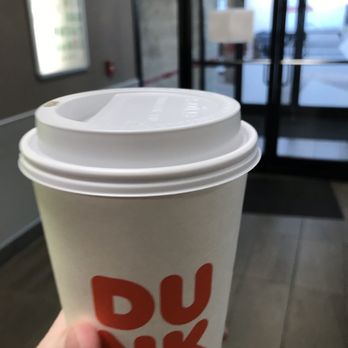 Dunkin' - a hand holding a cup of coffee - Coffee & Tea Near Me - Tecumseh, Kansas Dunkin' - a hand holding a cup of coffee - Coffee & Tea Near Me - Tecumseh, Kansas