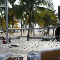 Look past the palms to see the crystal clear water on the upstairs deck