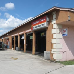 Village Green Tire & Auto Service Center - View of the Shop from Village Green Drive just behind Dunkin Donunts