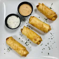 Dozzy's Grill - Buffalo Spring Rolls! Succulent chicken breast, mozzarella cheese, buffalo sauce, parsley garnish, fried golden brown