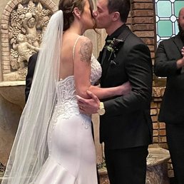Bride and groom kissing at ceremony fountain. Note how not many decorations were needed because the venue is beautiful as is. Bride and groom kissing at ceremony fountain. Note how not many decorations were needed because the venue is beautiful as is.