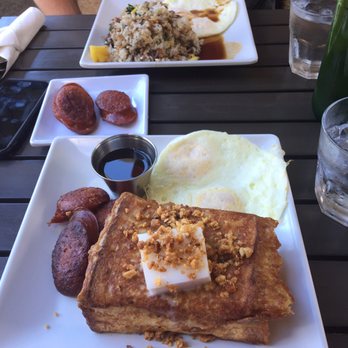 Anuenue Cafe - Macadamia nut French toast with coconut something on top, and pork fried rice in the back - Cafes Near Me - Koloa, Hawaii