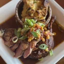 Iron Chest Steakhouse - Our roasted 1/2 duck and savory cornbread pudding