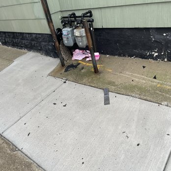 Amherst Roofing - Garbage in my neighbors driveway.  Found four nails too. - Roofing Near Me - East Amherst, New York