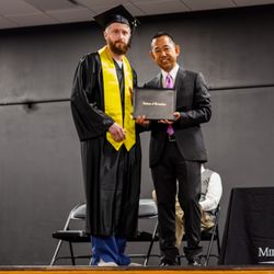 Milwaukee Career College - Milwaukee Career College President, Jack Takahashi, posing with a graduate during the graduation ceremony.