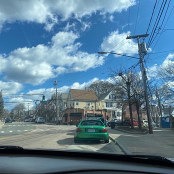 Green T Coffee Shop - a green car driving down a street - Coffee & Tea Near Me - Roslindale, Massachusetts