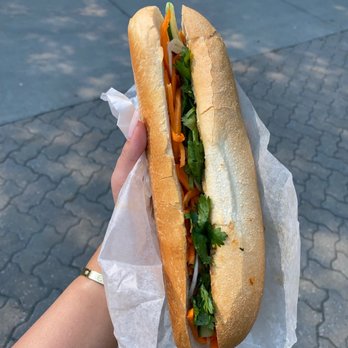 Thi Thi Vietnamese Subs - a person holding a sandwich - Vietnamese Near Me - Calgary, Alberta