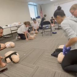 Strengthening Opportunities Actions Resources - Demonstrating proper hand placement for CPR on an adult.