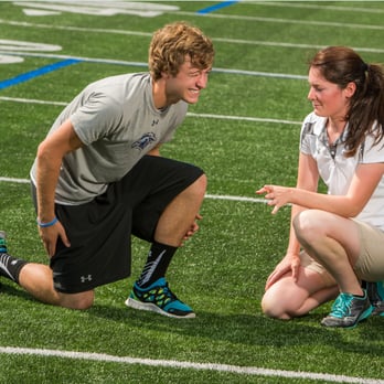 Pivot Physical Therapy - Pivot athletic trainer Katie Cicia working with a student athlete to determine what area of his leg is causing the most pain. - Physical Therapy Near Me - Columbia, Maryland