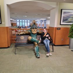 MSU Union - Sparty statue with a visitor.