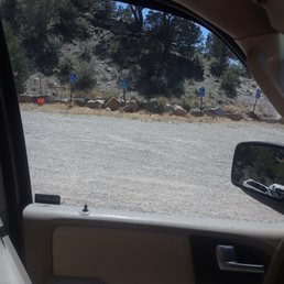 Handicapped parking across a gravel lot from the yurts
