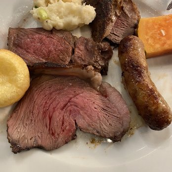Churrasco de Brasil - Plate of carne: steak, pork sausage, pork, and New York steak, mashed potatoes and bread - Brazilian Near Me - Tucson, Arizona