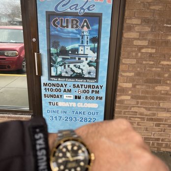 Havana Cafe - a man's hand holding a watch - Cuban Near Me - Indianapolis, Indiana