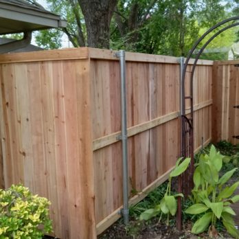 Built Better Inside & Out - a wooden fence with metal posts - General Contractors Near Me Built Better Inside & Out - a wooden fence with metal posts - General Contractors Near Me