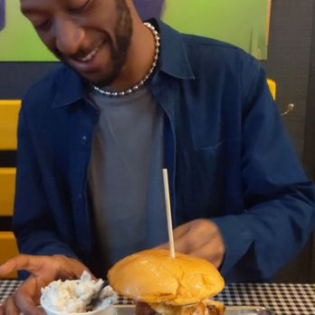 Stack City BBQ & Beer - A cutie enjoying a large potato salad and the donk, double. The Donk Potato Salad - Barbeque Near Me - Austin, Texas