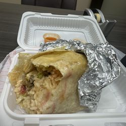 Ashly’s Tacos Y Pupuseria - 1/2 way of a lengua burrito and so far mostly rice and a hint of meat, lettuce tomato sour cream and cheese