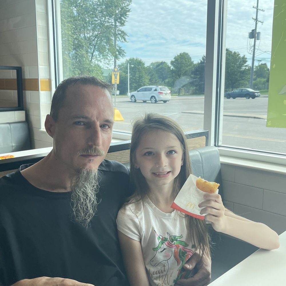 McDonald's - a man and a little girl sitting at a table - Burgers Near Me - Battle Creek, Michigan