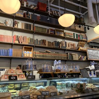 Caffè Nero - Wall of books with sandwich display - Coffee & Tea Near Me - Boston, Massachusetts