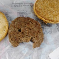 McDonald's - This is the burger they served me.  Big bite taken out of it.