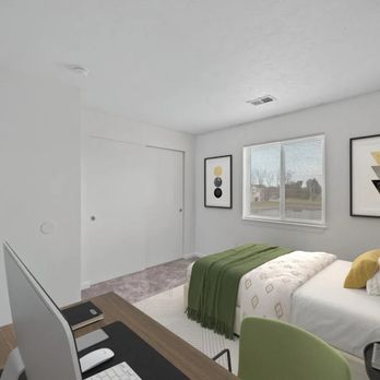 Crystal Glen - A bedroom with a bed, desk, and chair. - Apartments Near Me - Findlay, Ohio Crystal Glen - A bedroom with a bed, desk, and chair. - Apartments Near Me - Findlay, Ohio