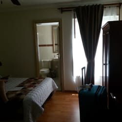 Posada del Marques - Other half of room with bathroom & standing closet/dresser.. also has a flat screen TV and complimentary water bottles daily.